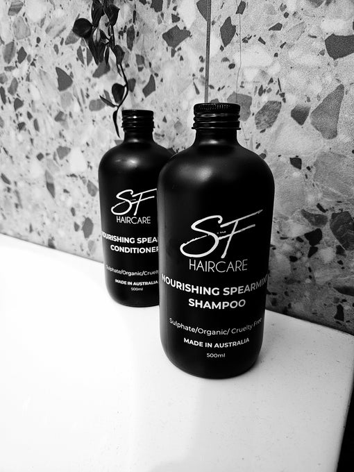 SFHaircare Nourishing Spearmint Shampoo and Conditioner on bathroom shelf